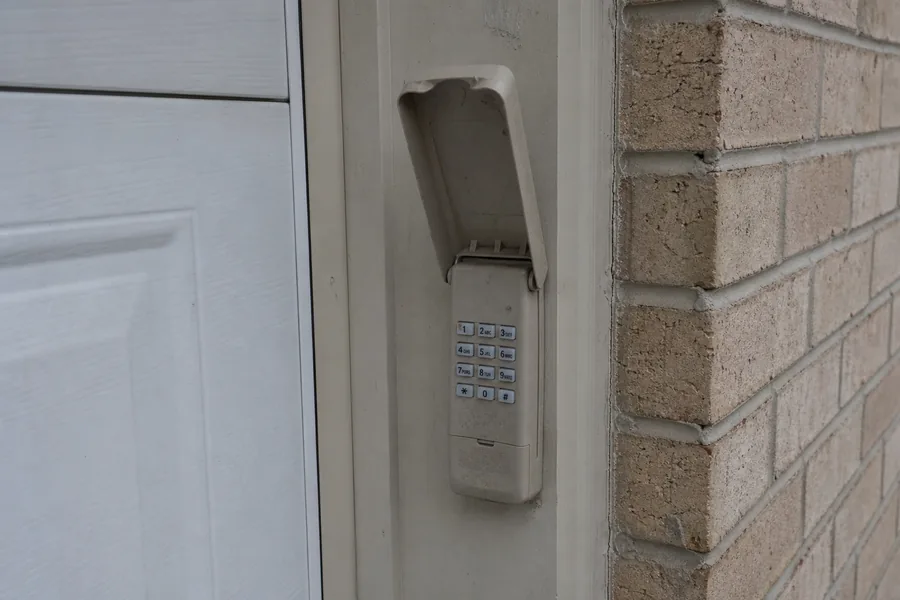Keypad beside a newly installed garage door