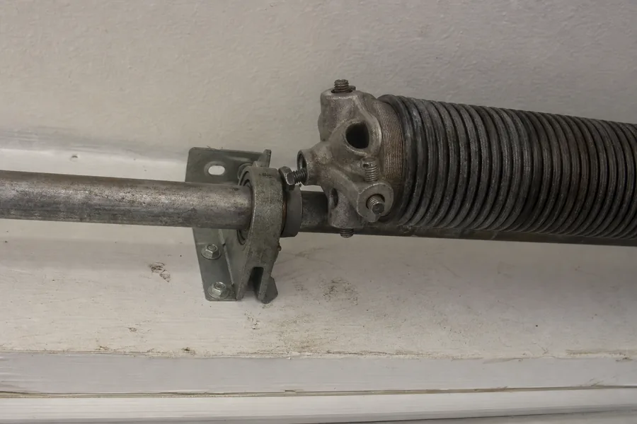 Torsion spring, winding cone and center bearing above a garage door in Topeka, KS
